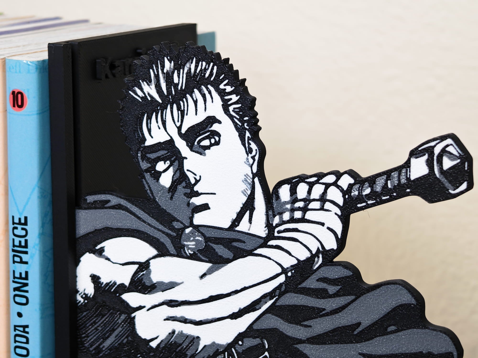 Sujetalibros de Guts de joven