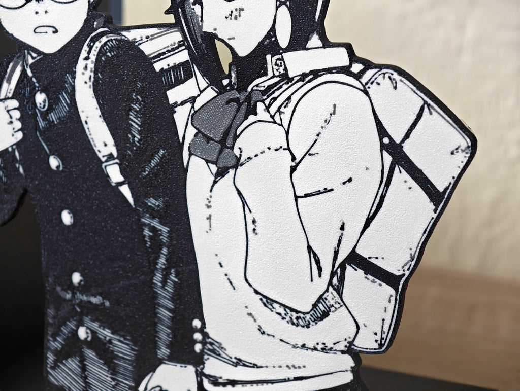 Sujetalibros de Momo y Okarun de la mano